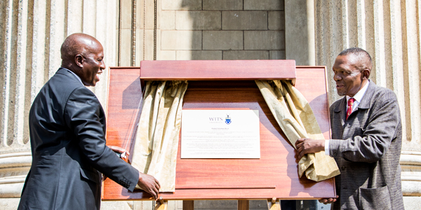 Wits Chancellor Justice Dikgang Moseneke and Dini Sobukwe, Robert Sobukwe's son unveiling a plaque of the renaming of Central Block to Robert Sobukwe Block